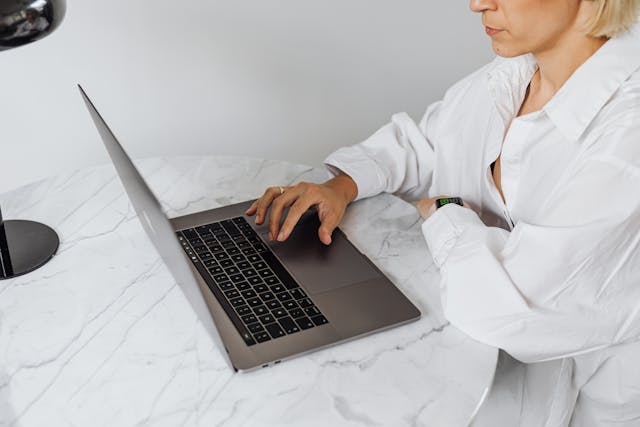 woman working on laptop on clean table